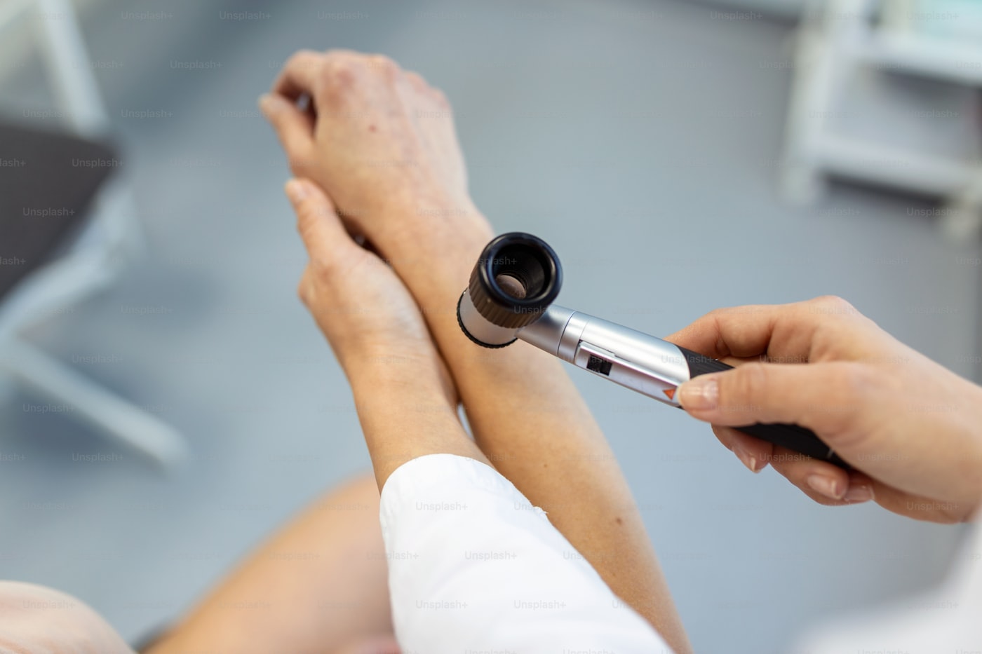 Dermatologist examining a patient's skin during consultation